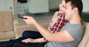 Young Couple Watching Tv at villa photo