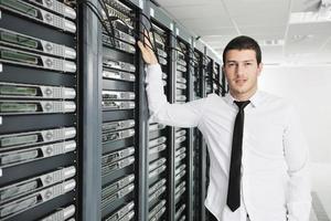 young it engeneer in datacenter server room photo