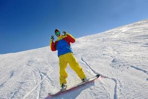 skiing on fresh snow at winter season at beautiful sunny day photo