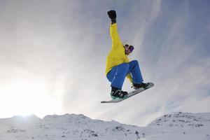 happy young man have fun at winter on mountain peak photo