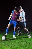 football players in competition for the ball photo