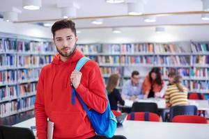 the student uses a laptop and a school library photo