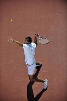 young man play tennis photo