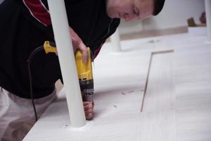 repairman working with drilling machine photo