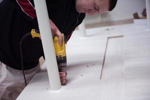 repairman working with drilling machine photo