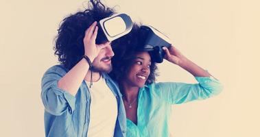 multiethnic couple getting experience using VR headset glasses photo