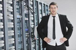 young engeneer in datacenter server room photo