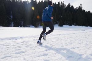 jogging on snow in forest photo