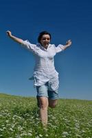 Young happy woman in green field photo