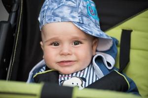 baby boy sitting in the pram photo