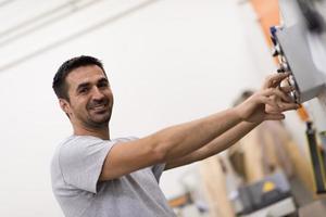 worker in a factory of wooden furniture photo