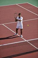 young man play tennis photo