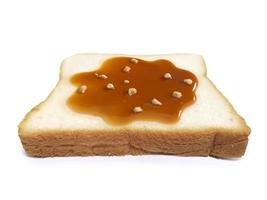 Almond Nuts and caramel sauce nuts on sliced bread on white background photo