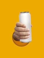 Man holding aluminum can on yellow background photo