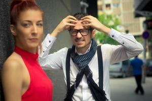 Woman is looking away and ignoring her frustrated boyfriend. photo