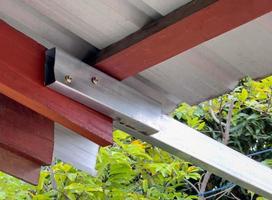 The carbon steel rectangular tube joined the wooden beam. photo