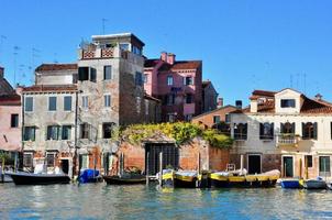 Non touristic part of Venice with empty silence colorful buildings, windows, streets and boats photo