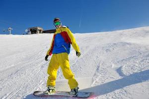 skiing on fresh snow at winter season at beautiful sunny day photo