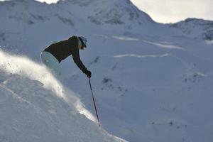 woman skiing on fresh snow at winter season photo