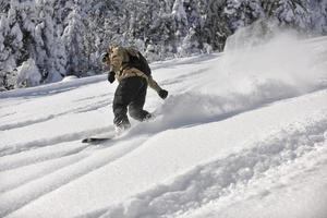 freestyle snowboarder jump and ride photo