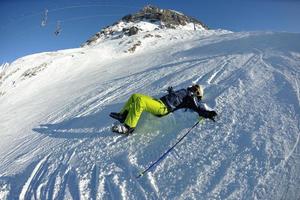 skiing on fresh snow at winter season at beautiful sunny day photo