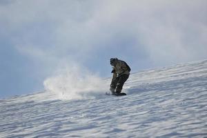 freestyle snowboarder jump and ride photo