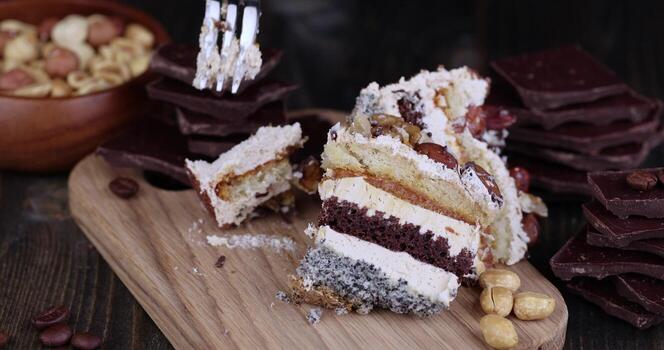 take a multi-layer cake with different layers with a fork photo