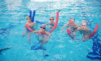 happy children group  at swimming pool photo