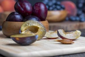 Ripe plums on the table in the kitchen photo