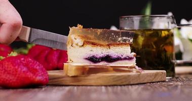 Cut a cheesecake with blueberry cream photo