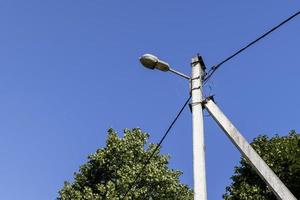 High-voltage power lines mounted on concrete poles photo