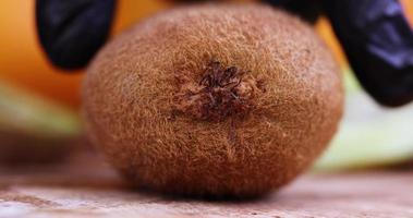 Cutting green kiwi fruit on a wooden board photo