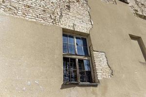 Part of the wall of an old building with damaged plaster photo