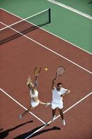 happy young couple play tennis game outdoor photo