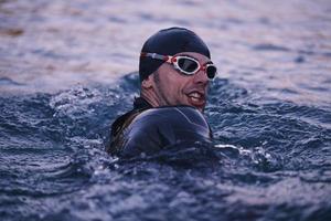 triathlete swimmer having a break during hard training photo