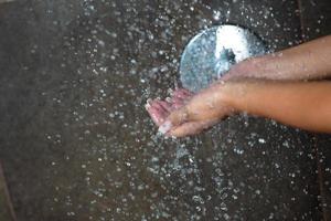 sexy young woman enjoing bath under water shower photo