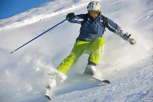 skiing on fresh snow at winter season at beautiful sunny day photo