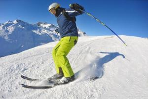 skiing on fresh snow at winter season at beautiful sunny day photo