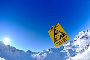 Sign board at High mountains under snow in the winter photo