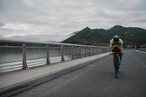 triathlon athlete riding a bike on morning training photo