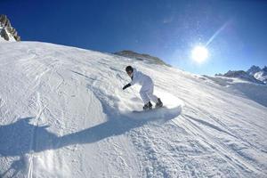 skiing on fresh snow at winter season at beautiful sunny day photo