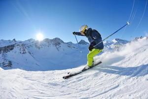 skiing on fresh snow at winter season at beautiful sunny day photo