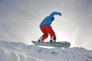 happy young man have fun at winter on mountain peak photo