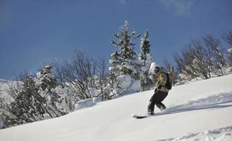 freestyle snowboarder jump and ride photo