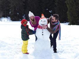 happy family making snowman photo