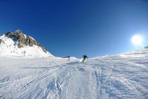 skiing on fresh snow at winter season at beautiful sunny day photo