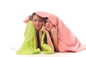 young girls under blanket smile photo