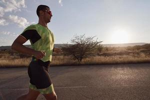 triathlon athlete running on morning trainig photo