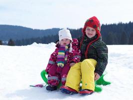 portrait of boy and baby girl on winter vacation photo