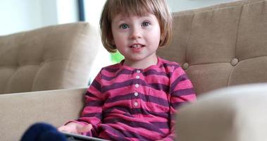 Child using tablet in modern apartment photo